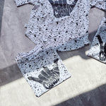 Detailed view of Good Vibes hand sign print on children’s white T-shirt. Sustainable long-lasting  printing techniques.