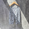Mono90s baby trousers laid flat showing bold abstract print and relaxed fit, made with Oeko Tex certified jersey fabric