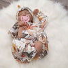 new baby girl wearing a flower printed babygrow with matching hat