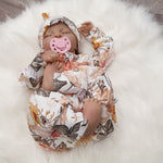 new baby girl wearing a flower printed babygrow with matching hat