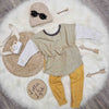 kids outfit flat lay image featuring L&L mustard grid leggings, sage green grid top, beige knitted beanie hat and black sunglasses