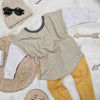 close up of the lottie and lysh sage grid 2-way top and mustard grid leggings