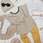 close up of the lottie and lysh sage grid 2-way top and mustard grid leggings