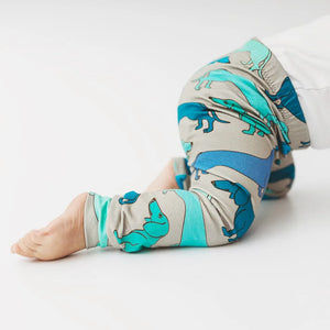 Baby wearing grey leggings with blue and green sausage dog print. Handmade in the Uk by Lottie & Lysh. 