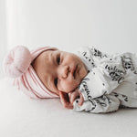 newborn baby girl baby girl wearing Lottie & Lysh welcome to the world babygro with baby pink baby turban headwrap