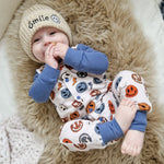 baby boy wearing Lottie & Lysh smile face romper and embroidered hat