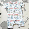 Flay lay image of  a Lottie & Lysh shortie romper in Beachside. The fabric features images of campervans and beachhuts
