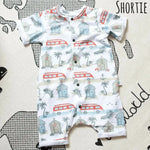 Flay lay image of  a Lottie & Lysh shortie romper in Beachside. The fabric features images of campervans and beachhuts